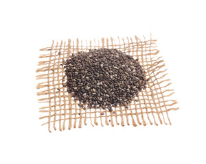Chia Seed. Grains over hessian fabric, isolated white background.
