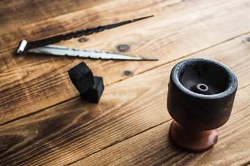 charcoal bowl for shisha on a wooden background