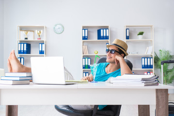 Businessman preparing for vacation in the office