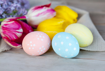 Easter eggs and spring flowers, Easter decoration on a wooden background, holiday concept.