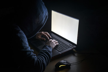 Young hacker  on a dark background