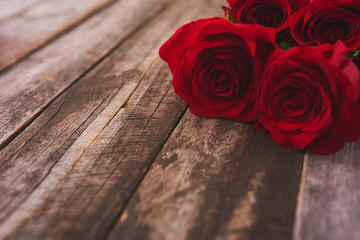 Valentines day background with red roses over wood board. Design mockup