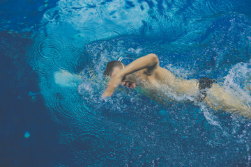 Obraz na płótnie Canvas Male swimmer at the swimming pool. Underwater photo. Male swimmer.