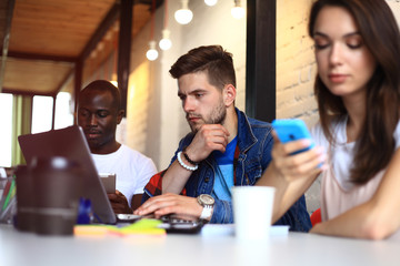 Startup Diversity Teamwork Brainstorming Meeting Concept.Business Team Coworkers Sharing World Economy Report Document Laptop.People Working Planning Start Up.Group Young Hipsters Discussing Cafe