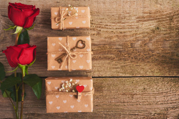 Valentines day background with red roses and gift box over wood board. Design mockup