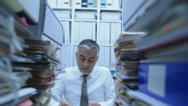 Business executive overwhelmed by work