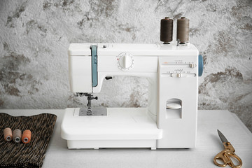 Sewing machine on table in tailor's workshop