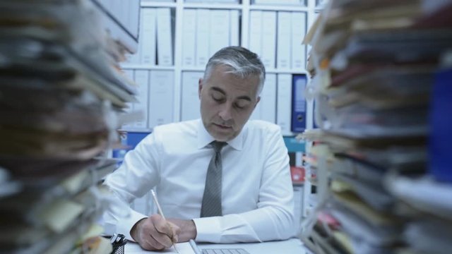 Business executive overwhelmed by work