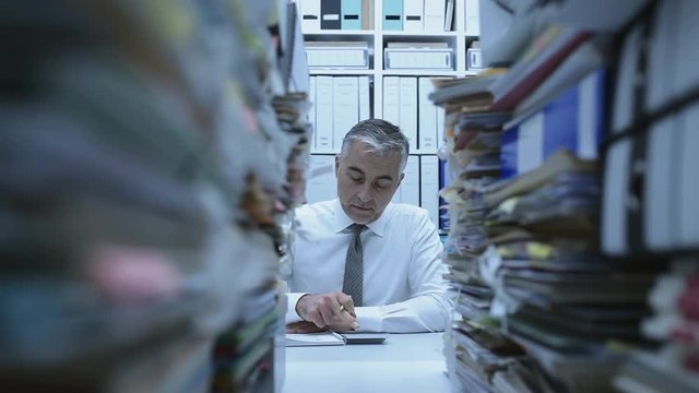 Business executive overwhelmed by work