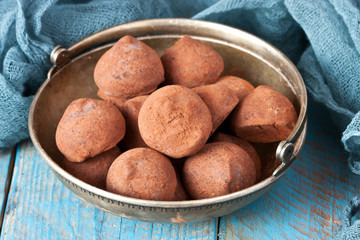 Chocolates Truffles  in vintage plate on wooden background