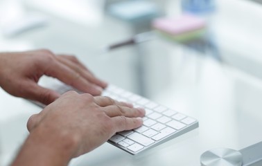 close-up of hand typing text on computer keyboard.