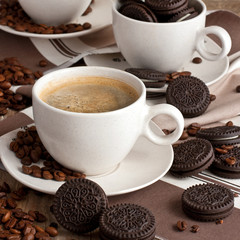 Chocolate biscuit cookies with coffee mug on wooden table
