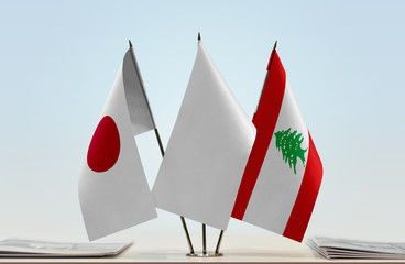 Flags of Japan and Lebanon with a white flag in the middle
