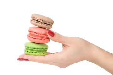 Woman hand holding macaroons isolated with clipping path