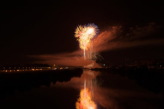 Yellow and orange fireworks with reflection in the river, water during festival in Zagreb
