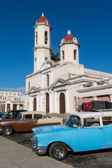 Old cars parked in the Jose Marti Park, in front of the Purisima Concepcion Cathedral. Cienfuegos, Cuba.