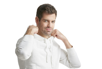 Casual young man portrait. Portrait of young man wearing hoodie while standing at isolated white background with copy space. 