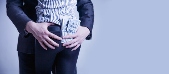 Love for money. Money over love. Man is paying for sex in Dollar banknotes. Escort and prostitution...