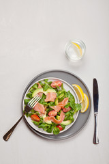 Fresh salad made of salmon, tomatoes and avocado