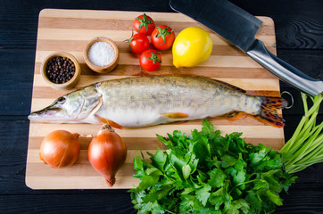 Uncooked fish on cutting board in meal preparation concept