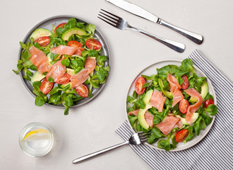 Fresh salad made of salmon, tomatoes and avocado