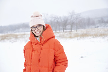 Fototapeta na wymiar Woman portrait in snowy landscape