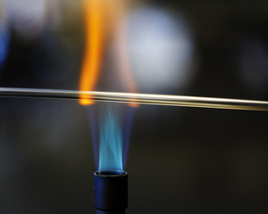 Glass bending in a bunsen burning flame in a chemistry lab