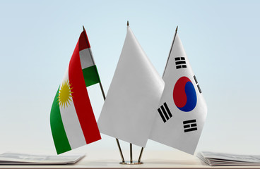 Flags of Kurdistan and South Korea with a white flag in the middle