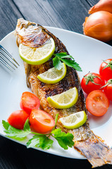 Fried fish served on the plate