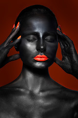  girl with black skin and red lips and nails on a red background