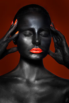  girl with black skin and red lips and nails on a red background