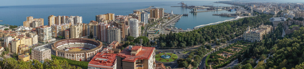 Panorama City skyline and harbour, sea port, bullring of Malaga overlooking the sea ocean in...
