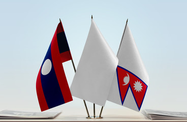 Flags of Laos and Nepal with a white flag in the middle