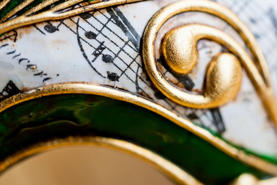 Close up of a green, gold and white decorative Venetian carnival mask