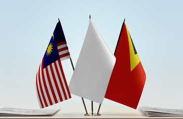 Flags of Malaysia and East Timor with a white flag in the middle