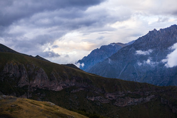 ountain panoramic view on a evening. Beautiful evening mountain landscape under bright sunset. Georgia Kazbegi