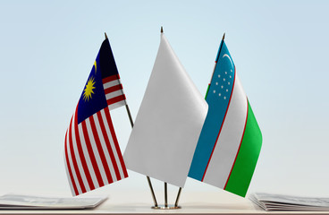 Flags of Malaysia and Uzbekistan with a white flag in the middle