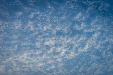 Clouds in the shape of angels float across a blue sky in Malaga, Spain, Europe