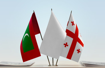 Flags of Maldives and Georgia with a white flag in the middle