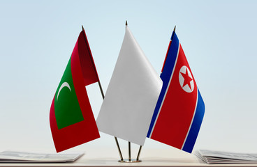 Flags of Maldives and North Korea with a white flag in the middle