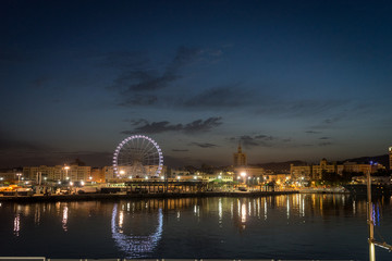 Fototapeta na wymiar View of Malaga city and giant wheel from harbour, Malaga, spain, Euope at night