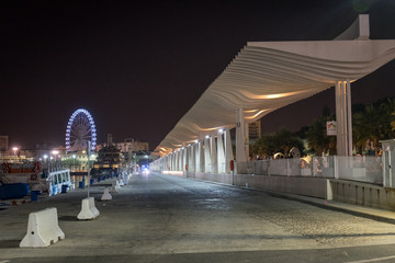 The walking path illuminated with the giant wheel with light and illumination at Malaga, Spain,...