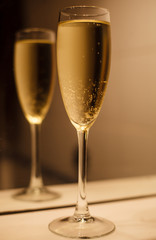 Glass of champagne with reflection in mirror