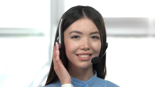 Cute asian girl with headset. Close up front view beautiful young asian girl face with headset smiling.