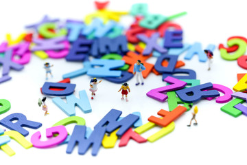 Miniature people : children and student with colorful wooden English alphabe,education concept.