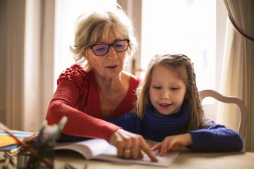 Grandmother teaching to her granddaughter