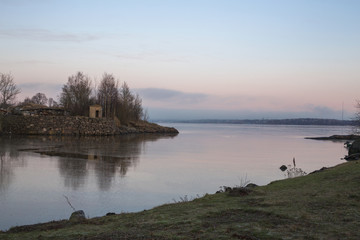 View of a pink sunset on the water of Suomenlinna island, near Helsinki in Finland. The sea is calm and there are no boats.