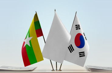 Flags of Myanmar and South Korea with a white flag in the middle