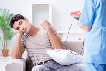Obraz premium Patient getting blood transfusion in hospital clinic