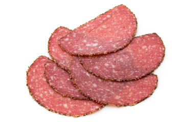 Salami slices isolated on the white background.